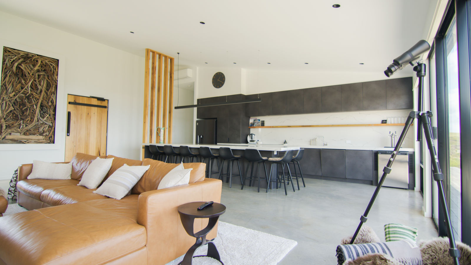 Living space opening onto the deck and the surging sea beyond